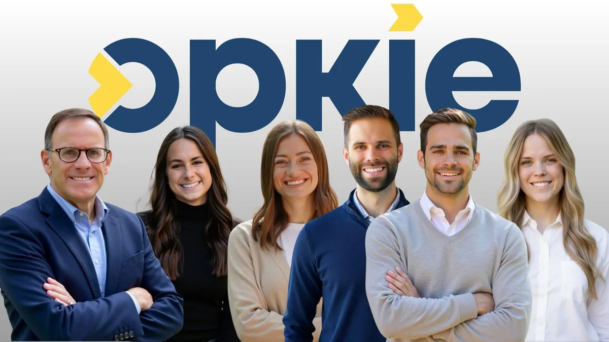 The Opkie team in front of the Opkie logo
